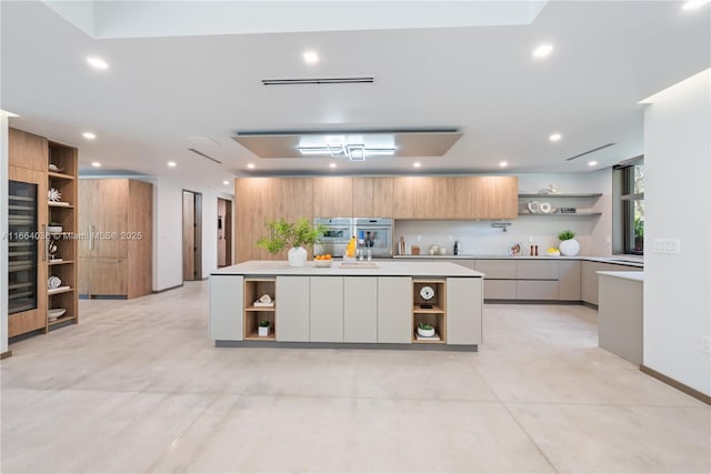 kitchen with a kitchen island, white cabinets, and backsplash