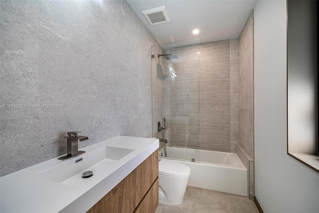 full bathroom with vanity, toilet, and tiled shower / bath combo