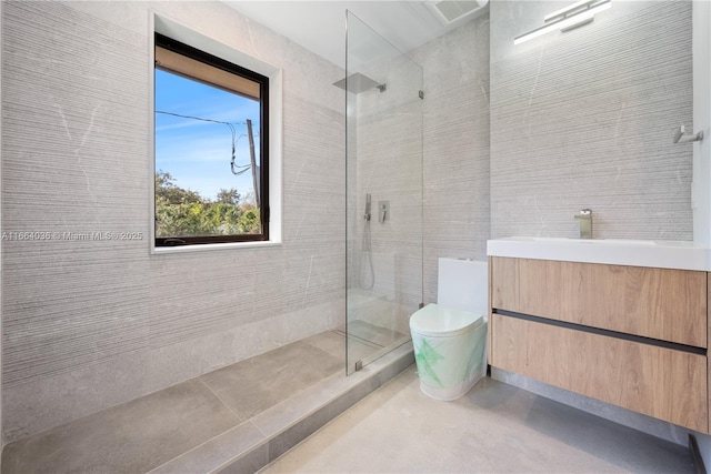 bathroom with vanity, a tile shower, and toilet