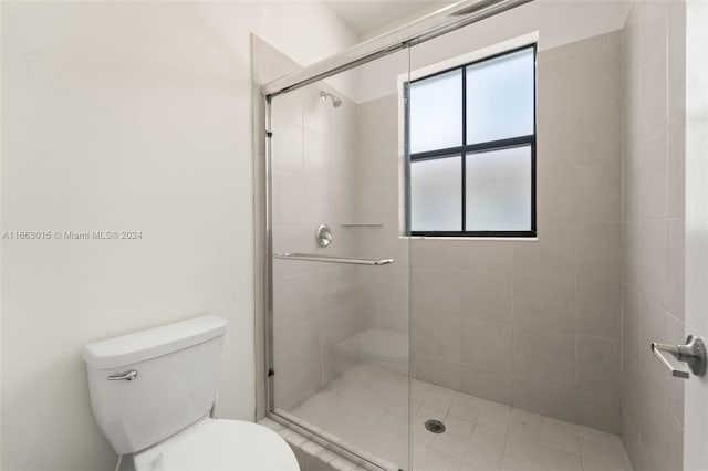 bathroom with walk in shower and toilet