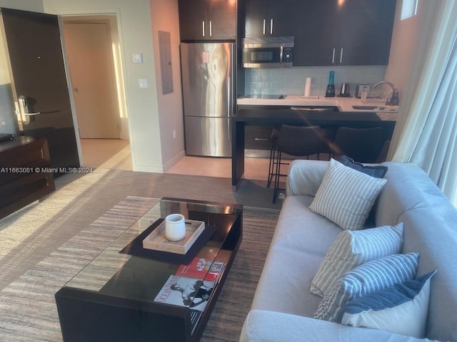 living room featuring sink and electric panel