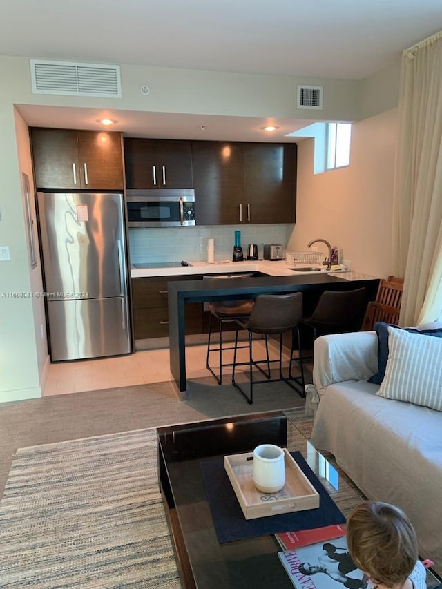 tiled living room featuring sink