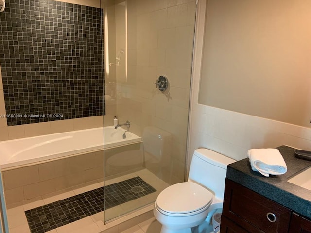 full bathroom with separate shower and tub, vanity, toilet, and tile patterned floors