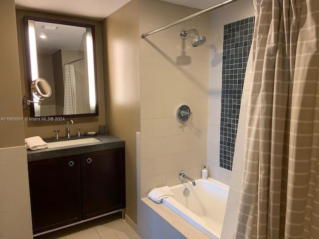 bathroom with shower / tub combo with curtain, tile patterned floors, and vanity