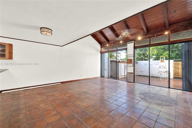 spare room with high vaulted ceiling, dark tile patterned flooring, beam ceiling, and wooden ceiling