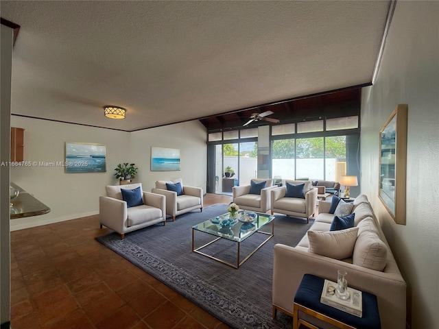 living room featuring ceiling fan and a textured ceiling