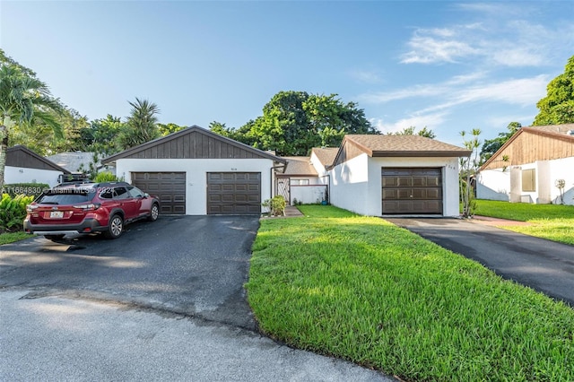 view of front of property featuring a garage and a front lawn