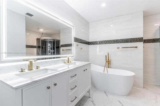 bathroom featuring shower with separate bathtub, vanity, and tile walls