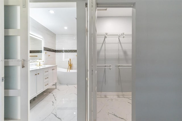 bathroom featuring vanity and a bath