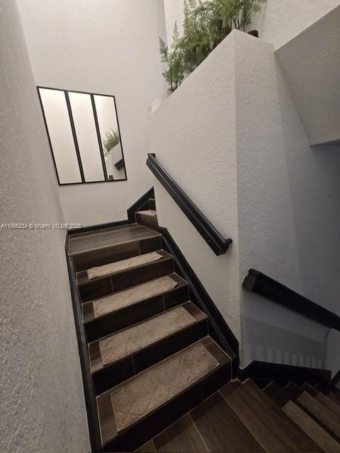 staircase with hardwood / wood-style floors