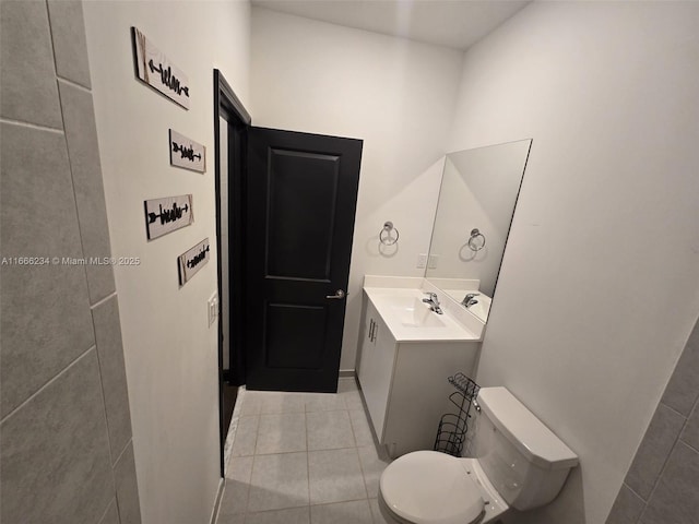 bathroom with tile patterned flooring, vanity, and toilet