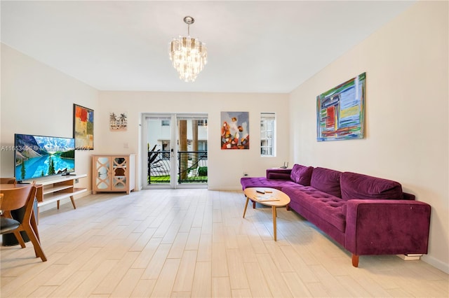 living room featuring an inviting chandelier and light hardwood / wood-style floors