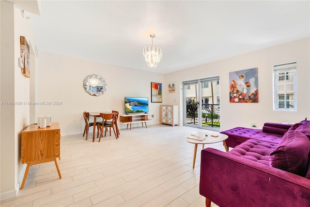 living room featuring a chandelier and light hardwood / wood-style floors