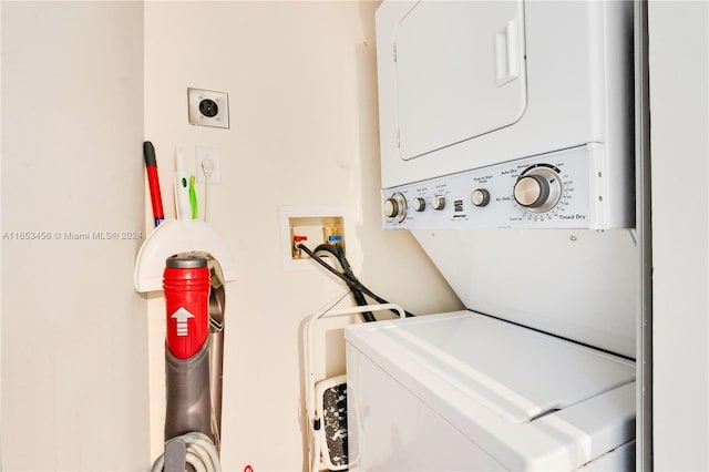 clothes washing area with stacked washer and dryer