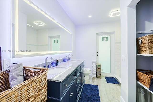 bathroom featuring hardwood / wood-style flooring, vanity, and toilet