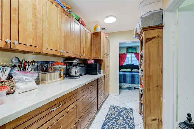 kitchen featuring light tile patterned flooring and light stone countertops