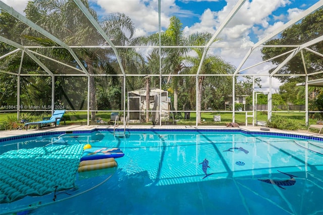 view of pool with a storage unit and a lanai