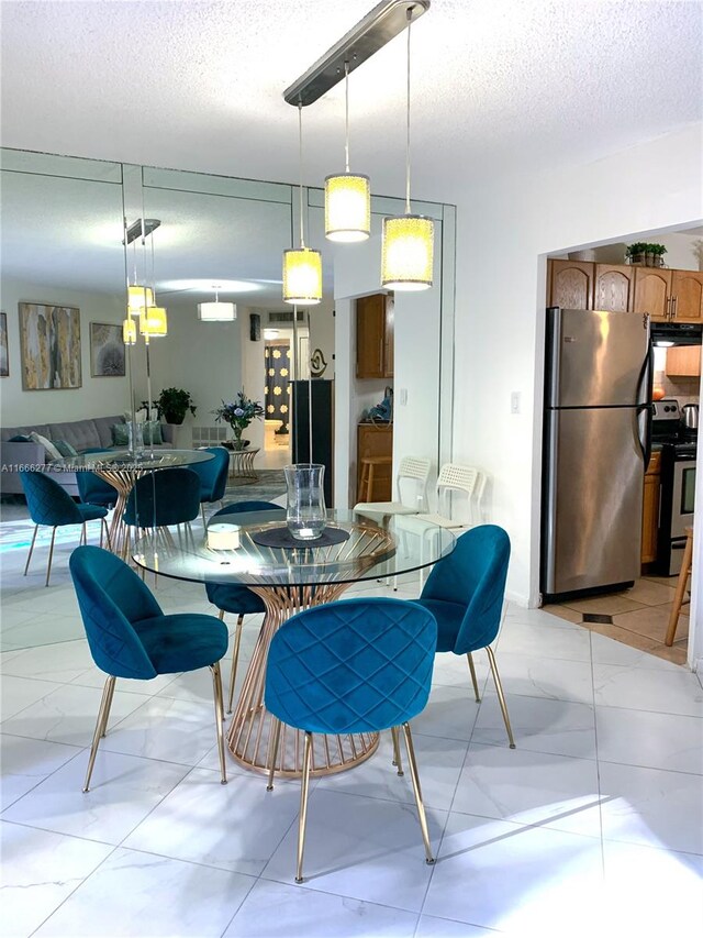 dining area featuring a textured ceiling