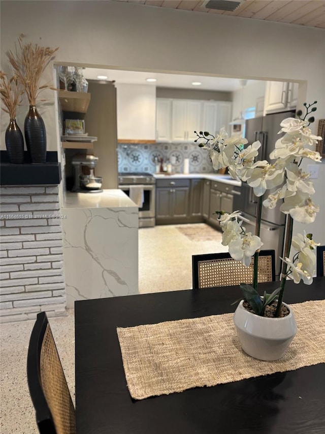 kitchen featuring white cabinets, wood ceiling, and appliances with stainless steel finishes