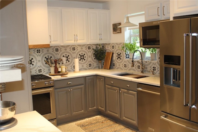 kitchen with gray cabinets, white cabinetry, sink, and stainless steel appliances