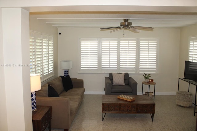 living room featuring a wealth of natural light and ceiling fan