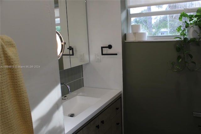 bathroom with decorative backsplash and vanity