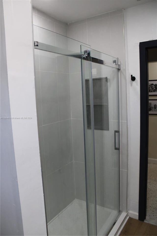 bathroom with a shower with shower door