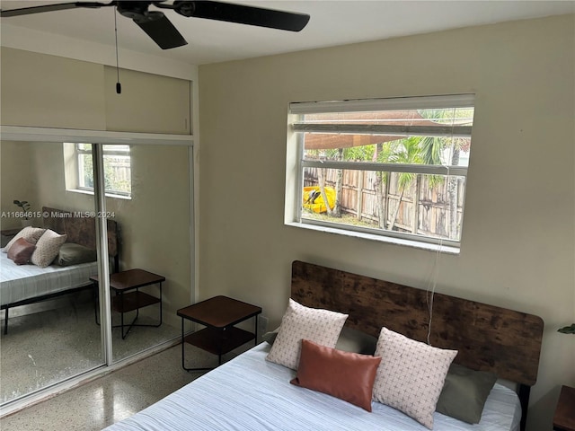 bedroom with multiple windows, a closet, and ceiling fan