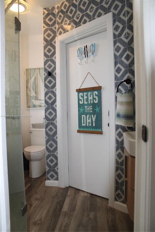 bathroom featuring hardwood / wood-style floors and toilet