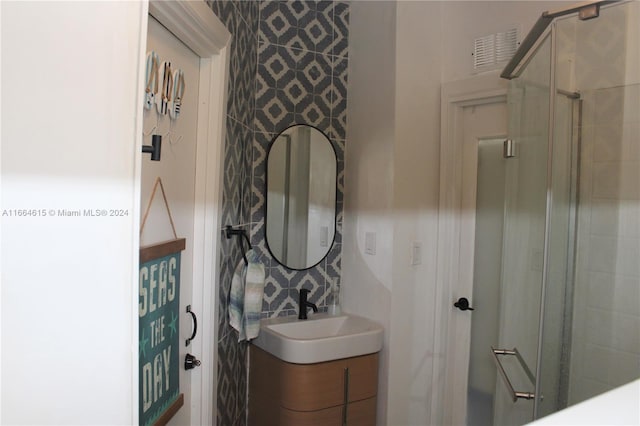 bathroom featuring vanity and an enclosed shower