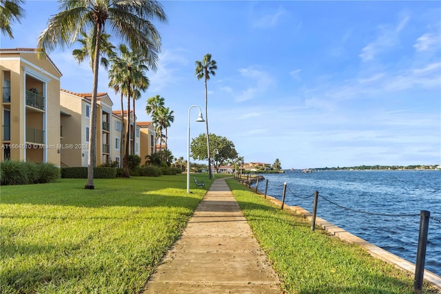 view of community with a water view and a yard