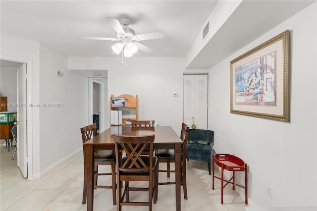 tiled dining area featuring ceiling fan