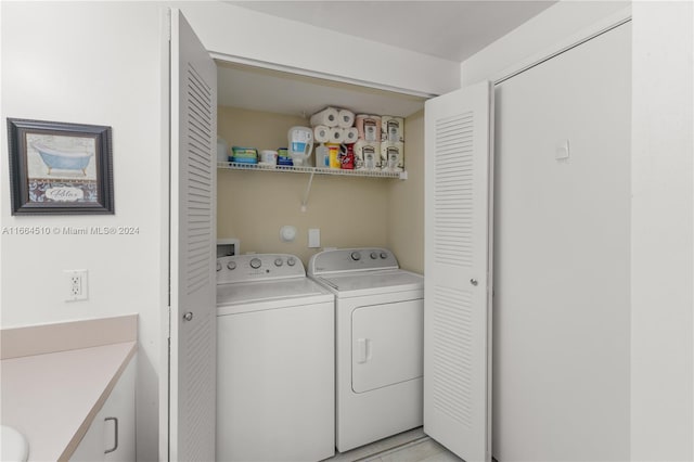 clothes washing area featuring washing machine and clothes dryer