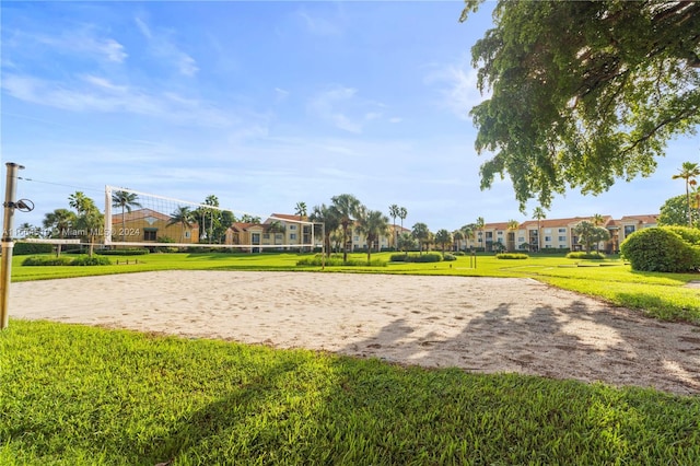 view of property's community featuring a yard and volleyball court