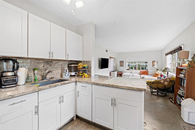 kitchen featuring white cabinets, kitchen peninsula, ceiling fan, and sink