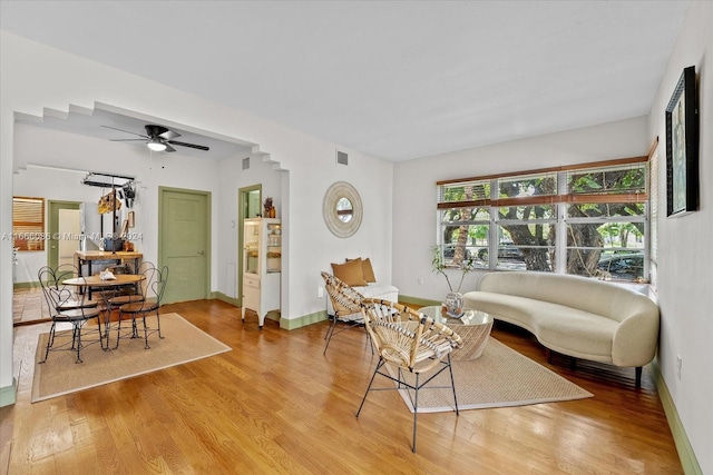 living room with ceiling fan and wood-type flooring