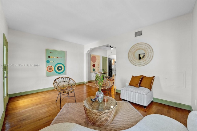 living room featuring ceiling fan and hardwood / wood-style flooring