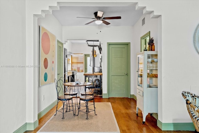 dining space featuring light wood-type flooring and ceiling fan