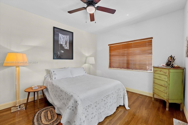 bedroom with ceiling fan and dark hardwood / wood-style flooring