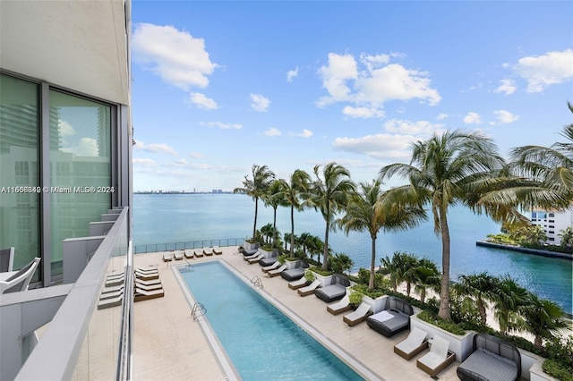 view of pool featuring a patio and a water view