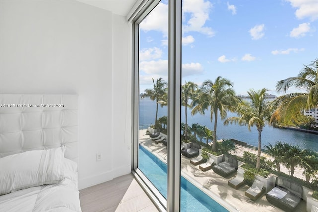 interior space with light hardwood / wood-style flooring and a water view