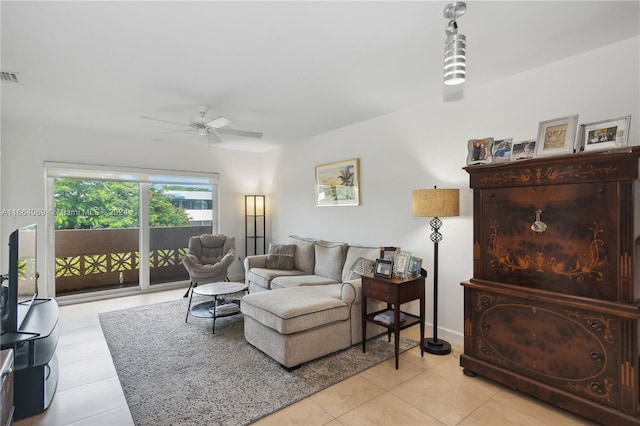 tiled living room featuring ceiling fan