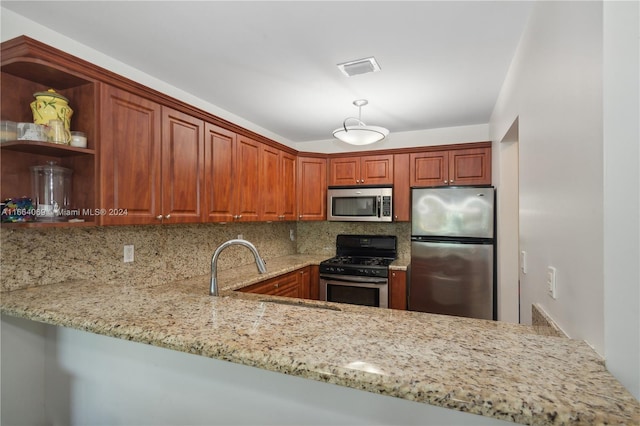 kitchen featuring backsplash, kitchen peninsula, light stone countertops, and stainless steel appliances