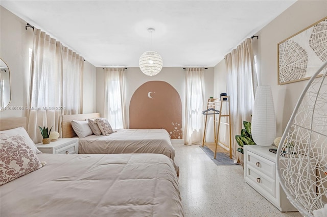 bedroom featuring an inviting chandelier