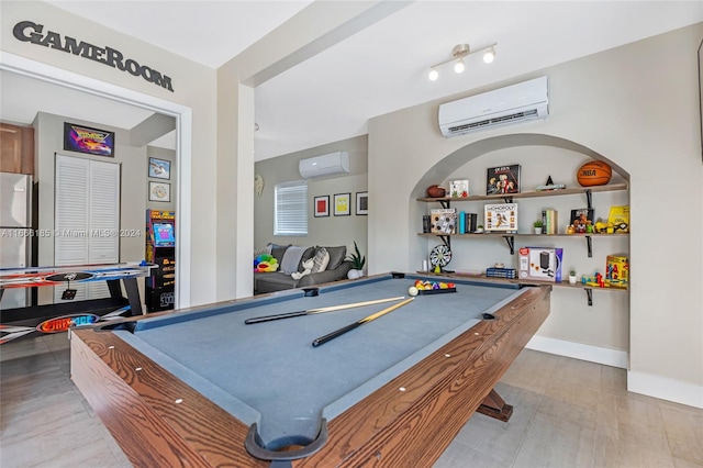 recreation room featuring hardwood / wood-style flooring, a wall mounted air conditioner, and pool table