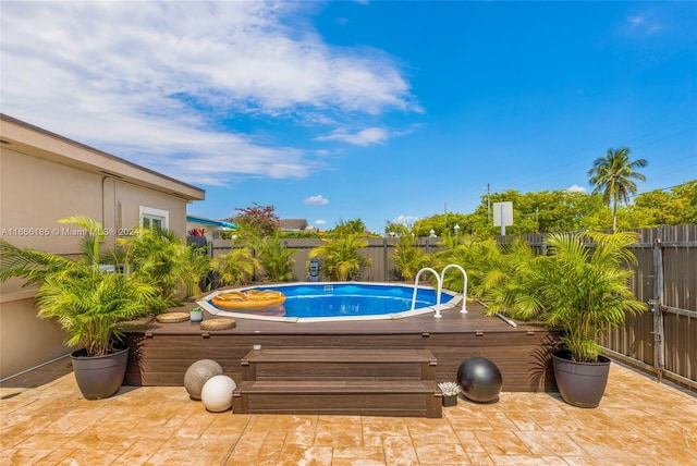 view of pool with a wooden deck