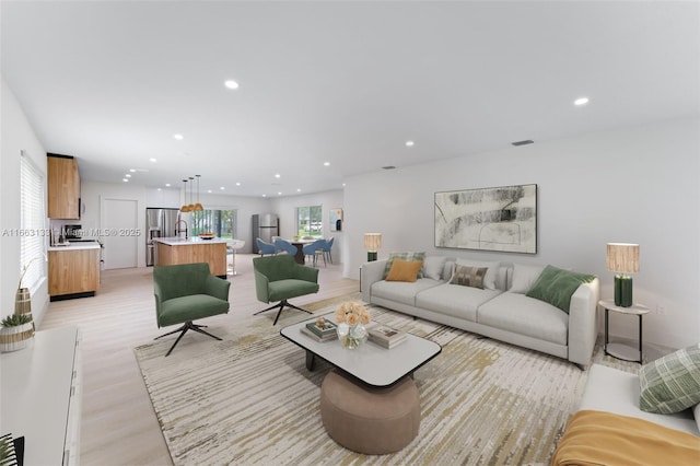 living room with light wood finished floors, visible vents, and recessed lighting