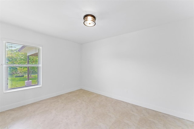 empty room featuring baseboards