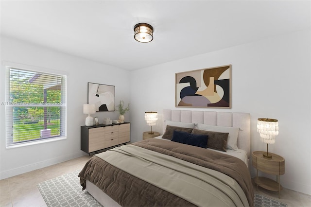 bedroom with light tile patterned floors and baseboards