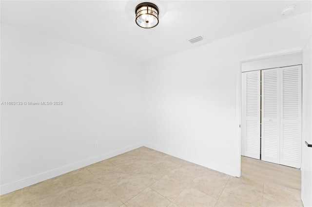 unfurnished bedroom with baseboards and visible vents